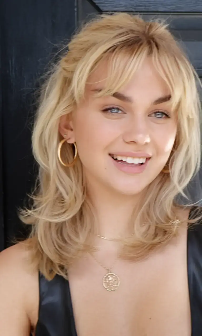 girl haircut summer ideas 2025 Layered Blonde Shag with Curtain Bangs
