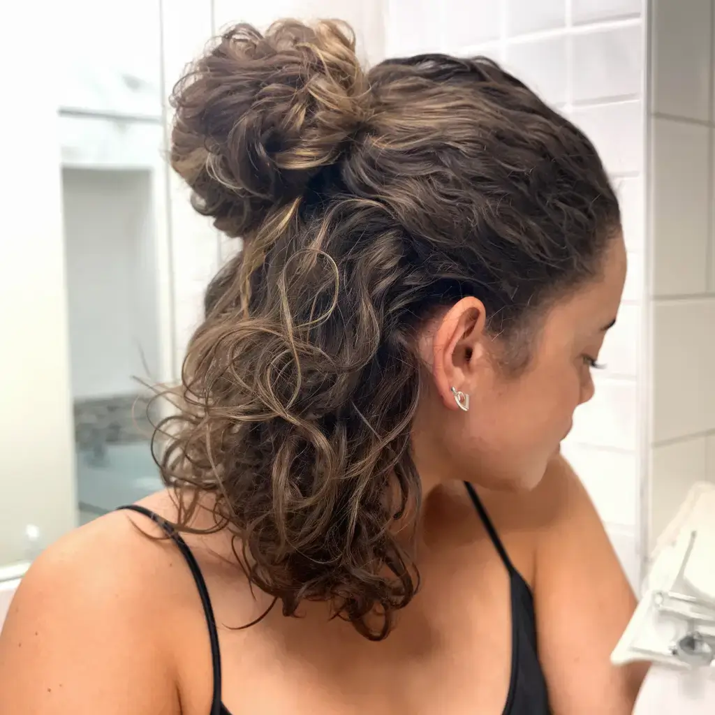 cute natural summer hairstyle ideas 2025 Half-Up Curly Bun with Loose Texture