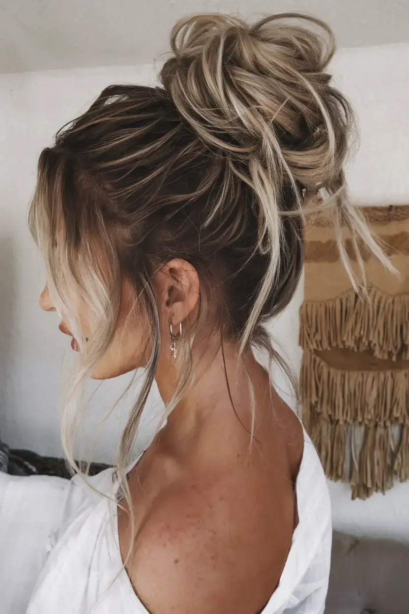easy summer hairstyles 2025 Messy High Bun with Loose Strands