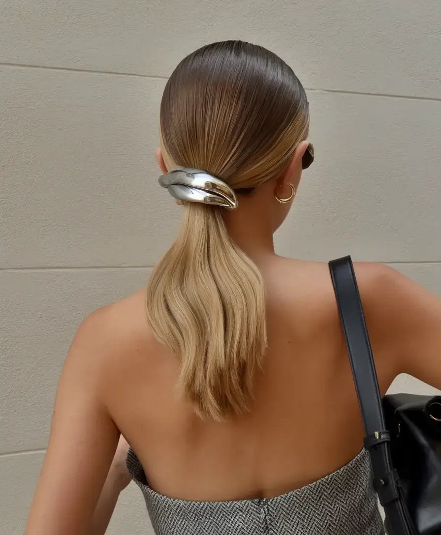 summer ponytail hairstyles 2025 Glossy Mid Pony with Metallic Barrette