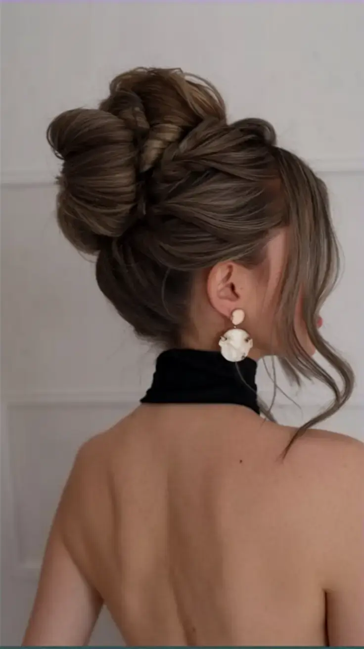 summer updo hairstyles 2025 High Twist Bun with Sculpted Detail