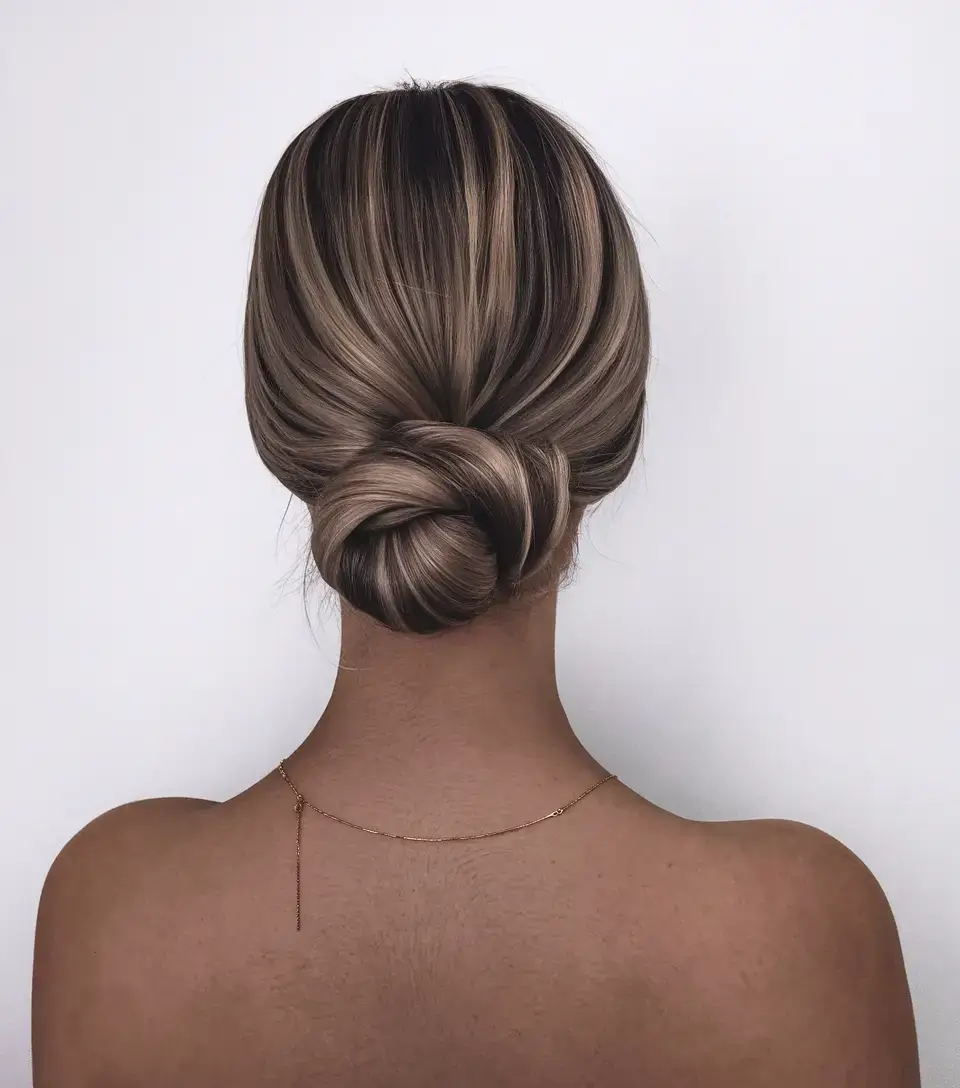 summer updo hairstyles 2025 Sleek Twisted Nape Bun