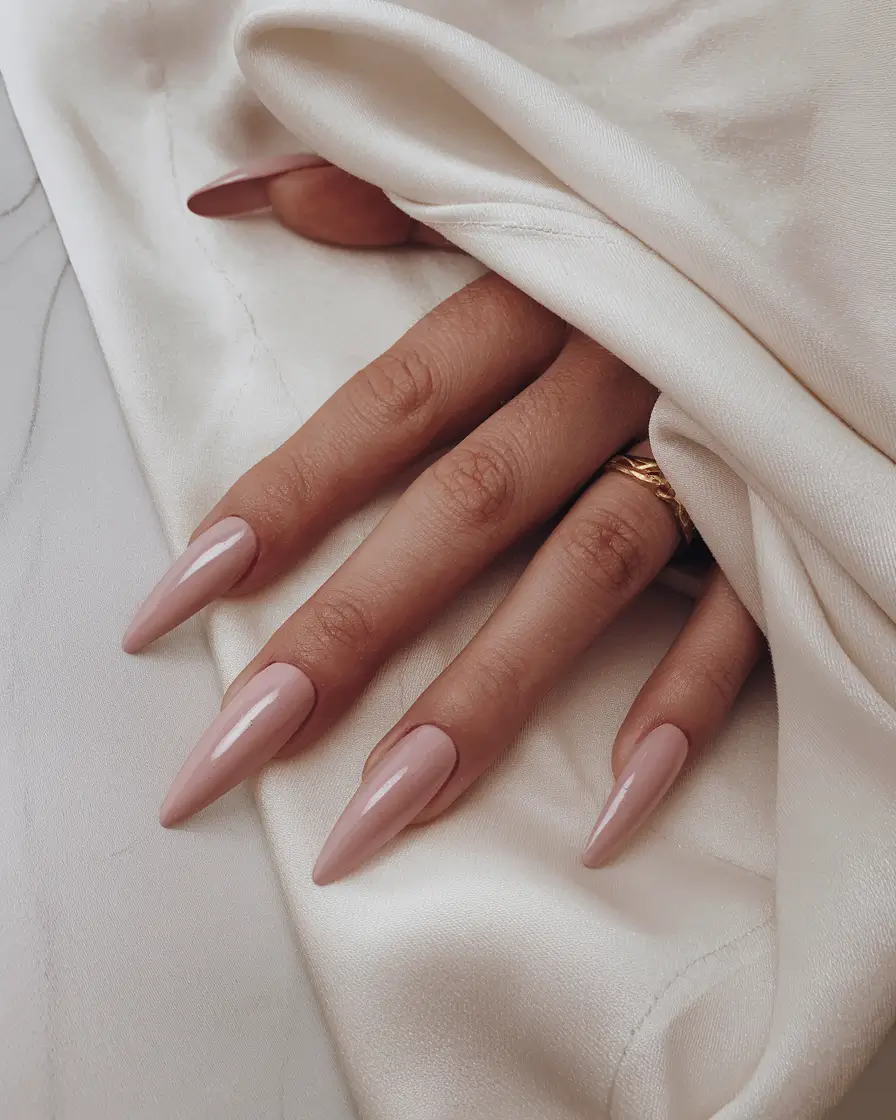 basic but chic summer nails 2025 Sharp Nude Stiletto