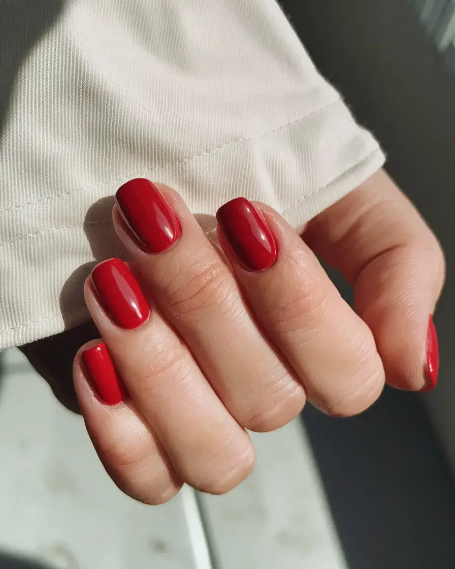 best july nail colors for 2025 Tomato Red: The It-Girl Power Color