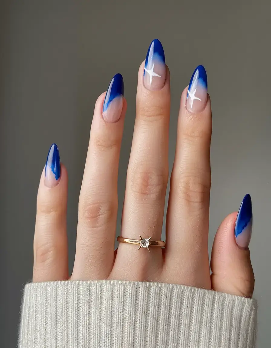cool blue nail ideas for summer 2025 Celestial Blue Fade with Star Accents