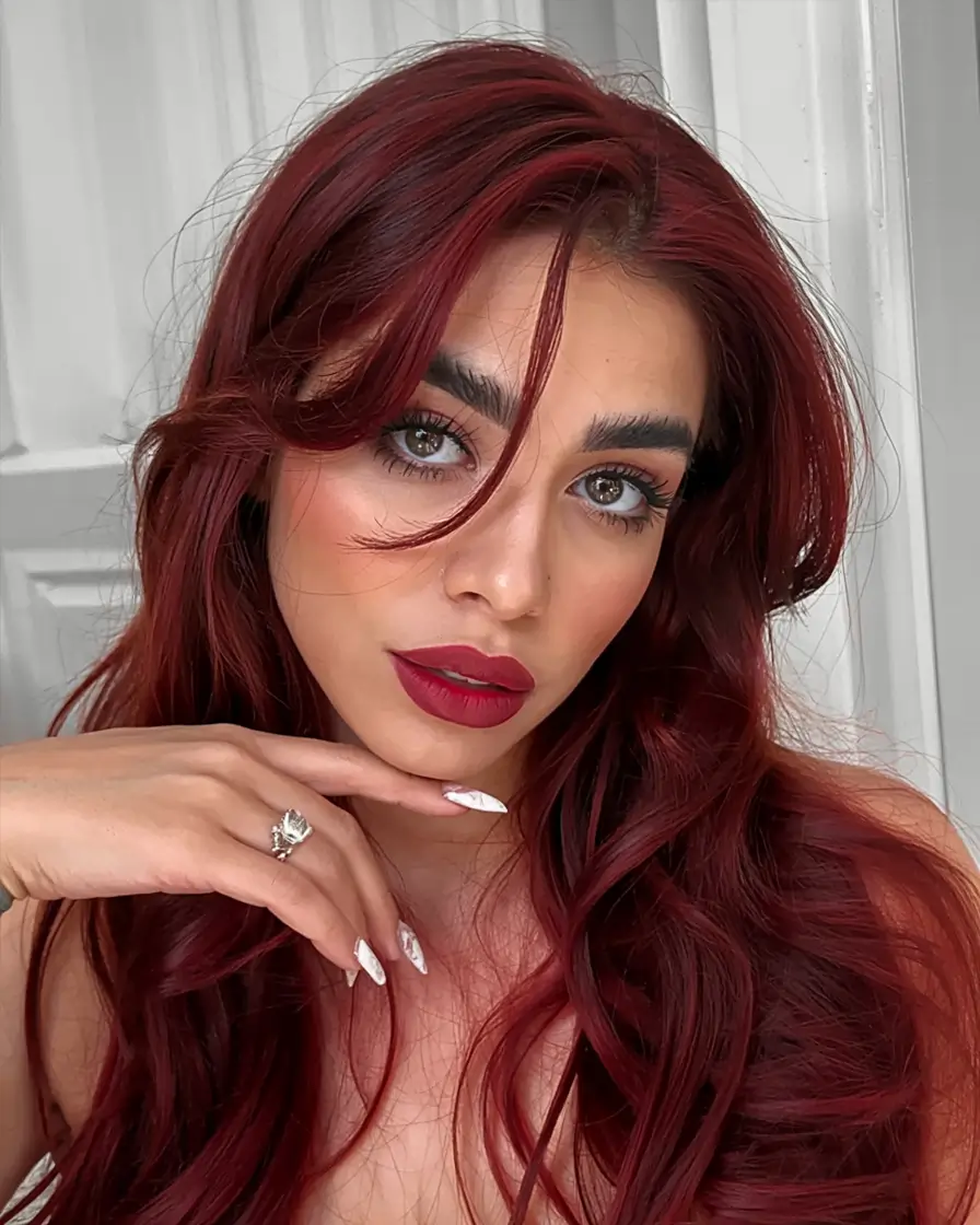 fall red hair color ideas 2025 Pinot Noir Curls with Flirty Face Layers