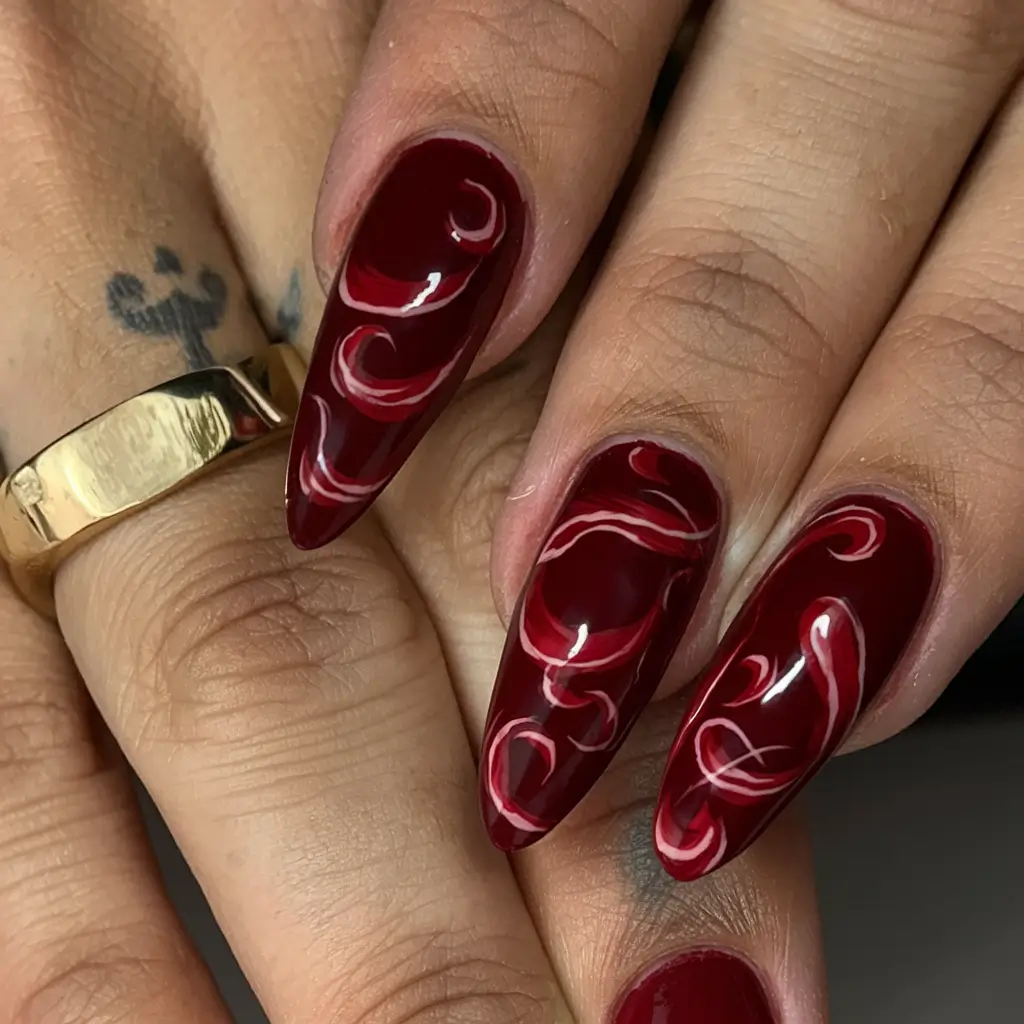 red summer nails that pop in 2025 Swirled Artistry in Red Tones