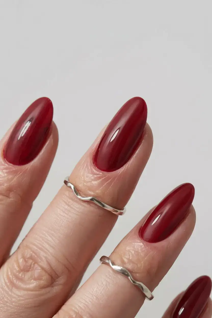 september nails color ideas 2025 Deep Cranberry on Almond Tips