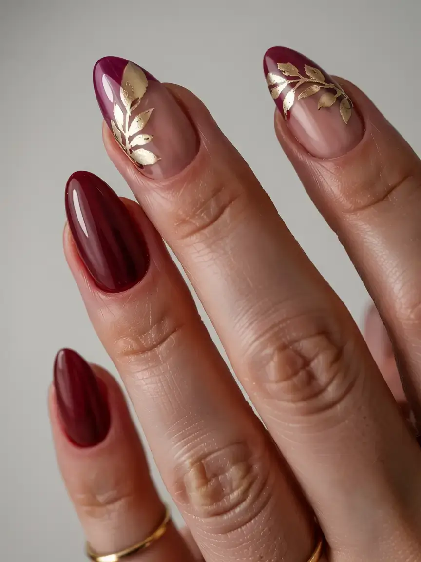 september nails design fall trends for 2025 Wine-Dipped Tips with Gilded Leaf Foil