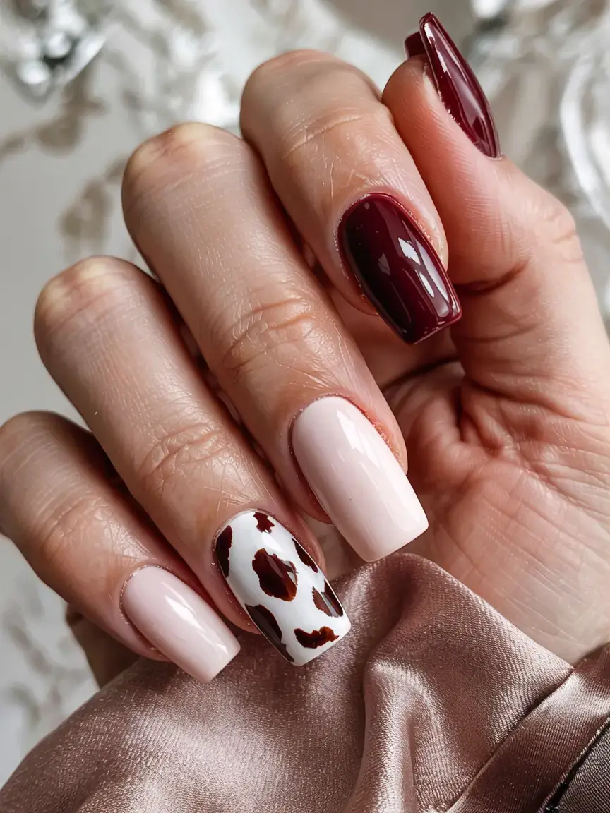 september nails design fall trends for 2025 Cow Print Accent with Cabernet Glam