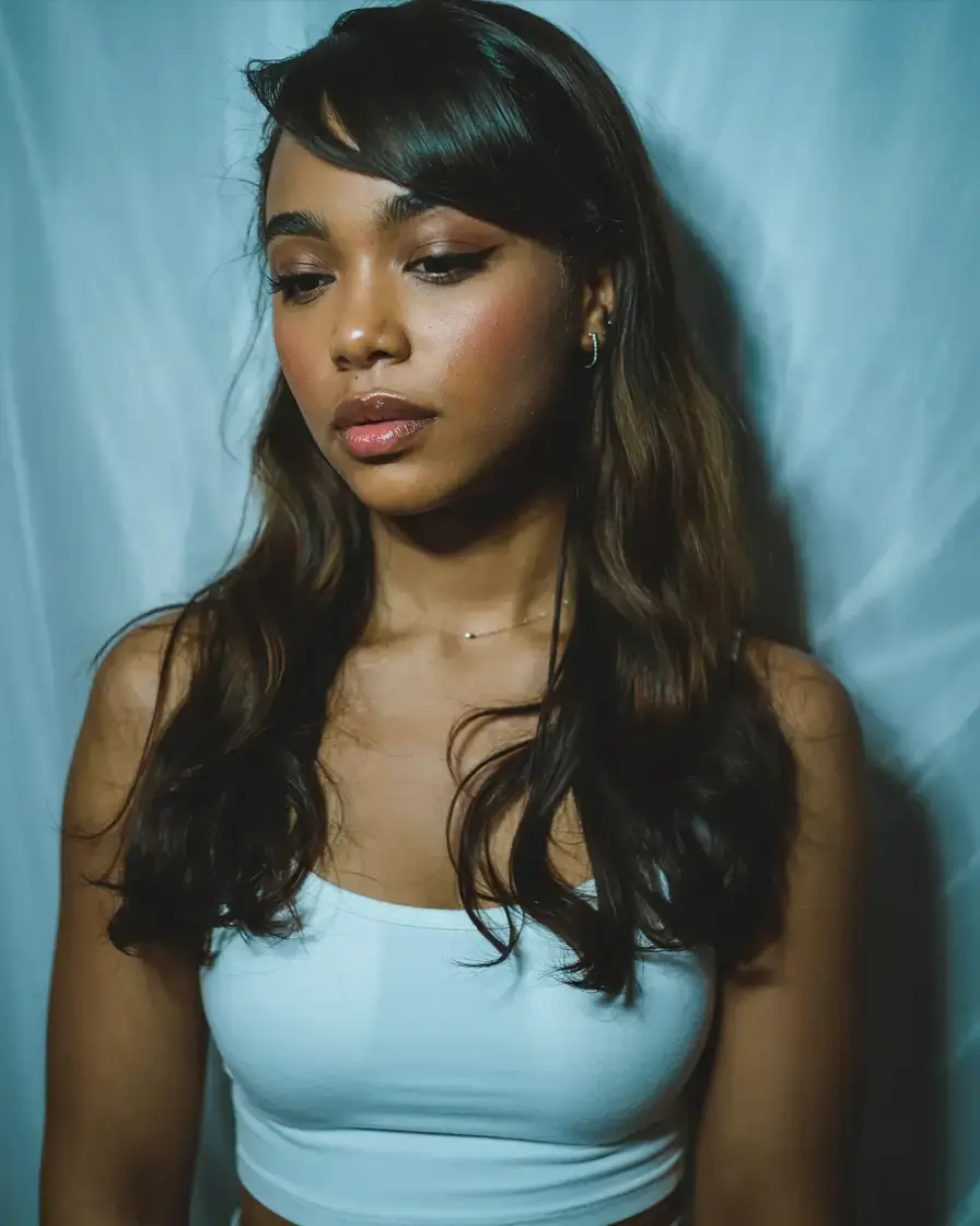 hairstyles for black women winter 2025 2026 Layered Glossy Blowout with Side Bangs