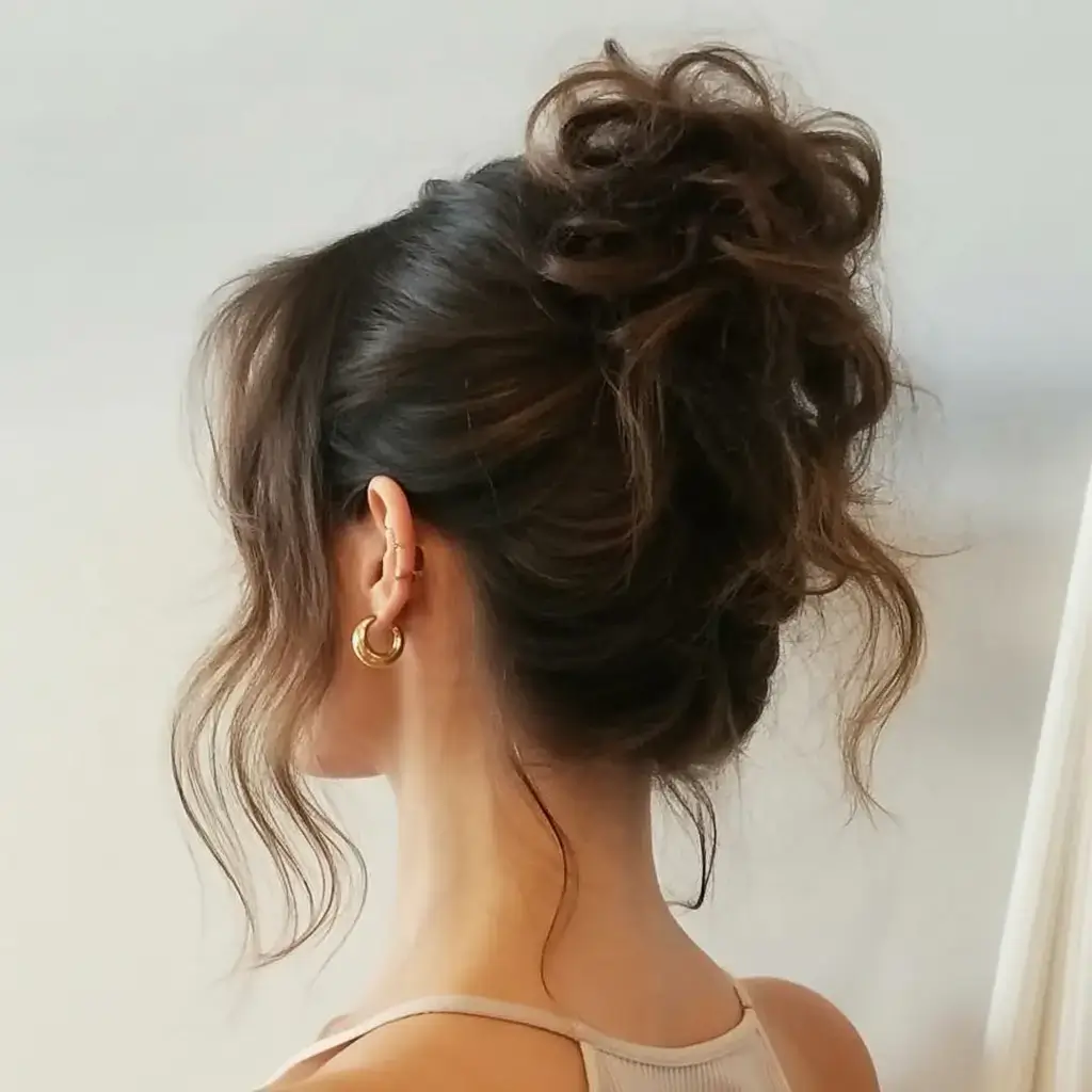 buns hairstyle ideas 2026 Unruly Chic with a High Crown