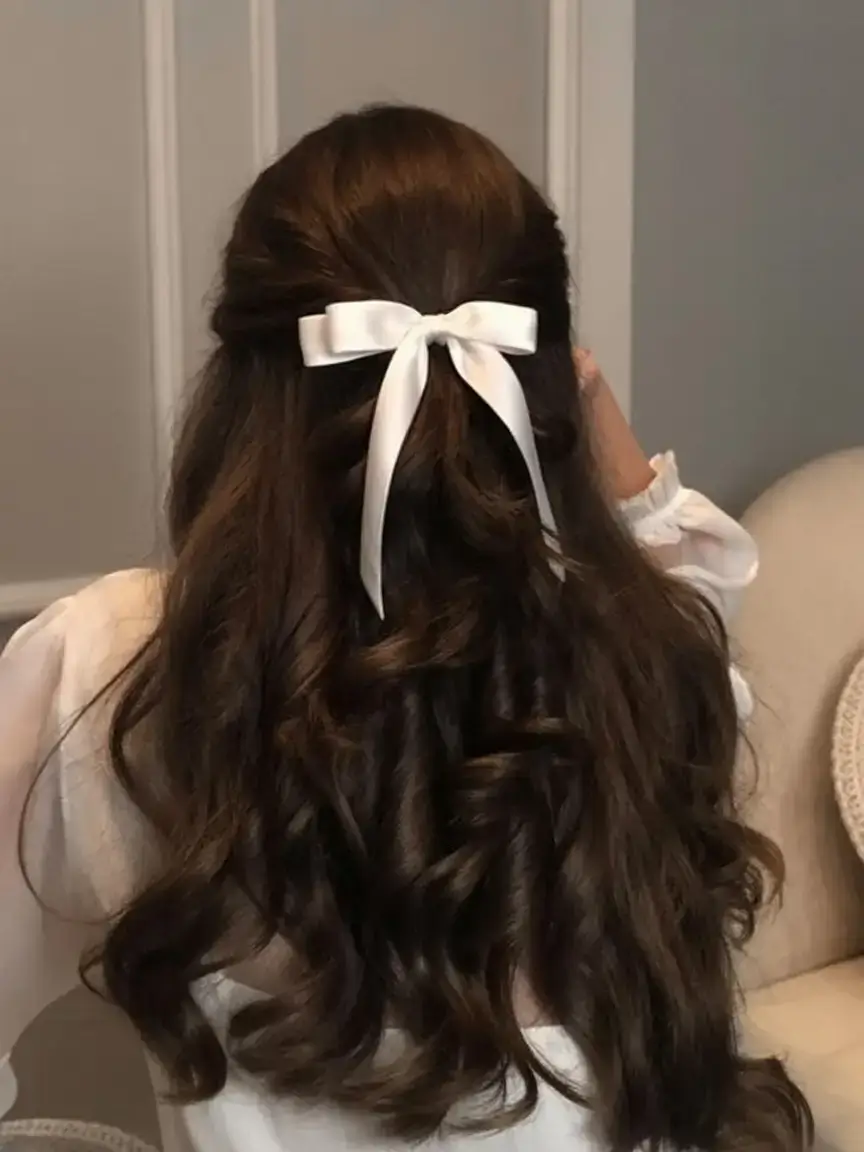 cute hairstyle ideas 2026+Voluminous Curls with a Classic White Bow