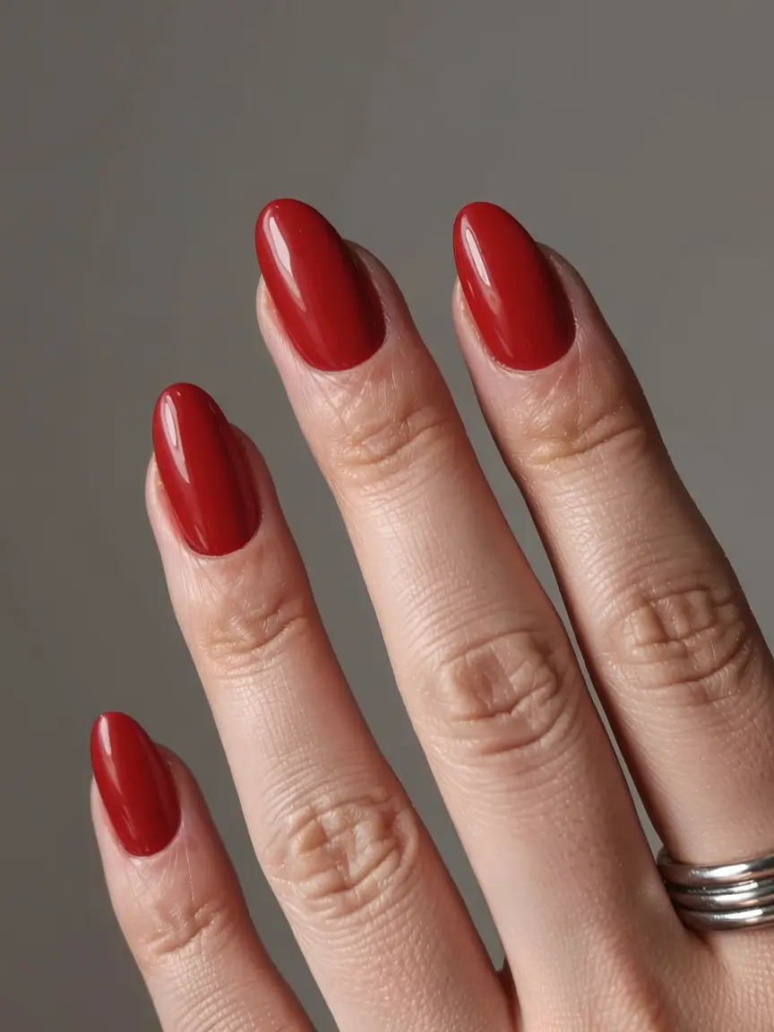 best red spring nails inspo 2026 Soft Brick Red in a Modern Almond Shape