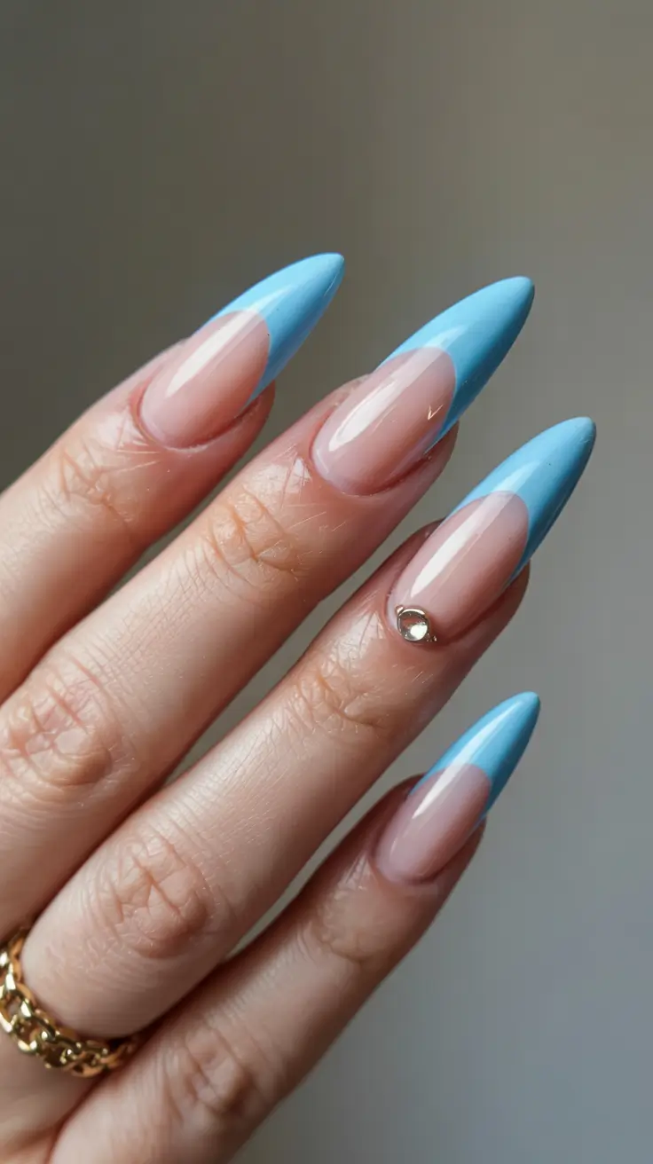 pastel spring stiletto nails 2026 Sky-Blue Crescent Stilettos With Minimalist Gem Detail