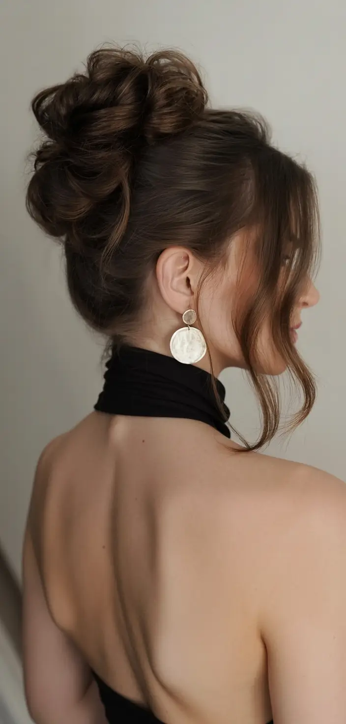 romantic spring wedding hairstyle 2026 Elegant Textured High Bun With Wispy Layers