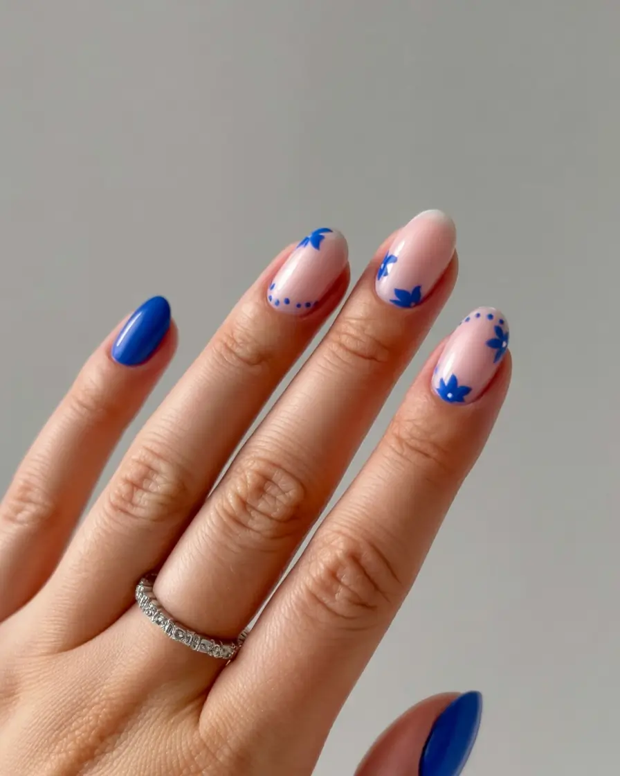 stylish blue spring nails for 2026 Blue Floral Accents with Royal Blue Solids