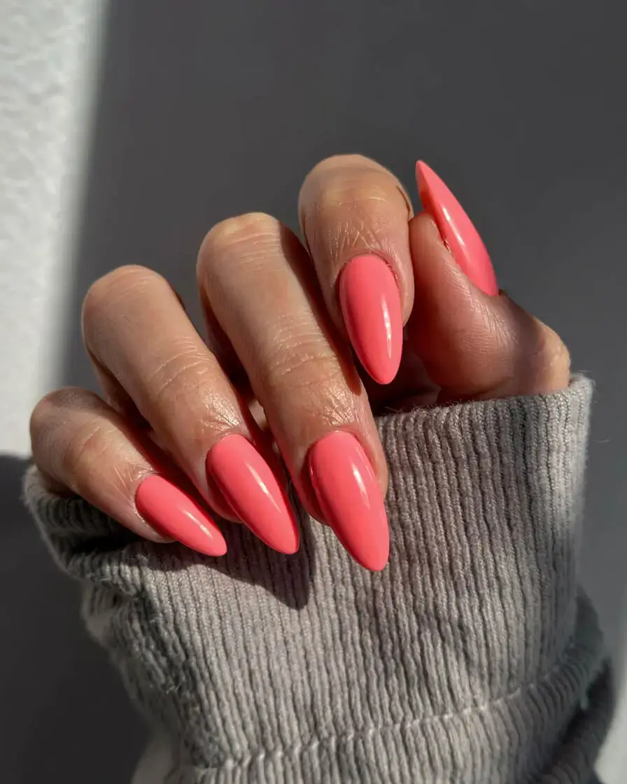 april nails colours spring 2026 Glossy Coral Almond Nails That Wake Up the Season