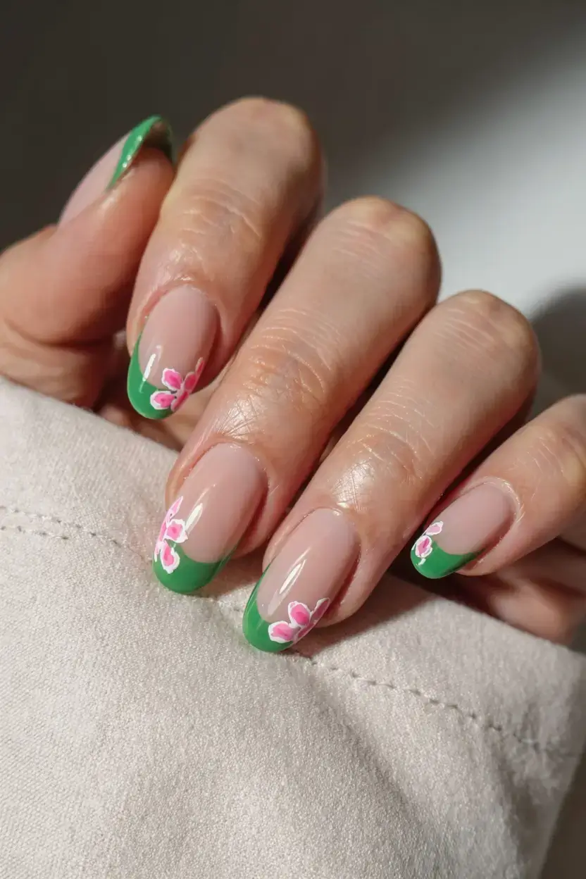april nails ideas spring 2026 Fresh Green French Tips with Tiny Blossom Details