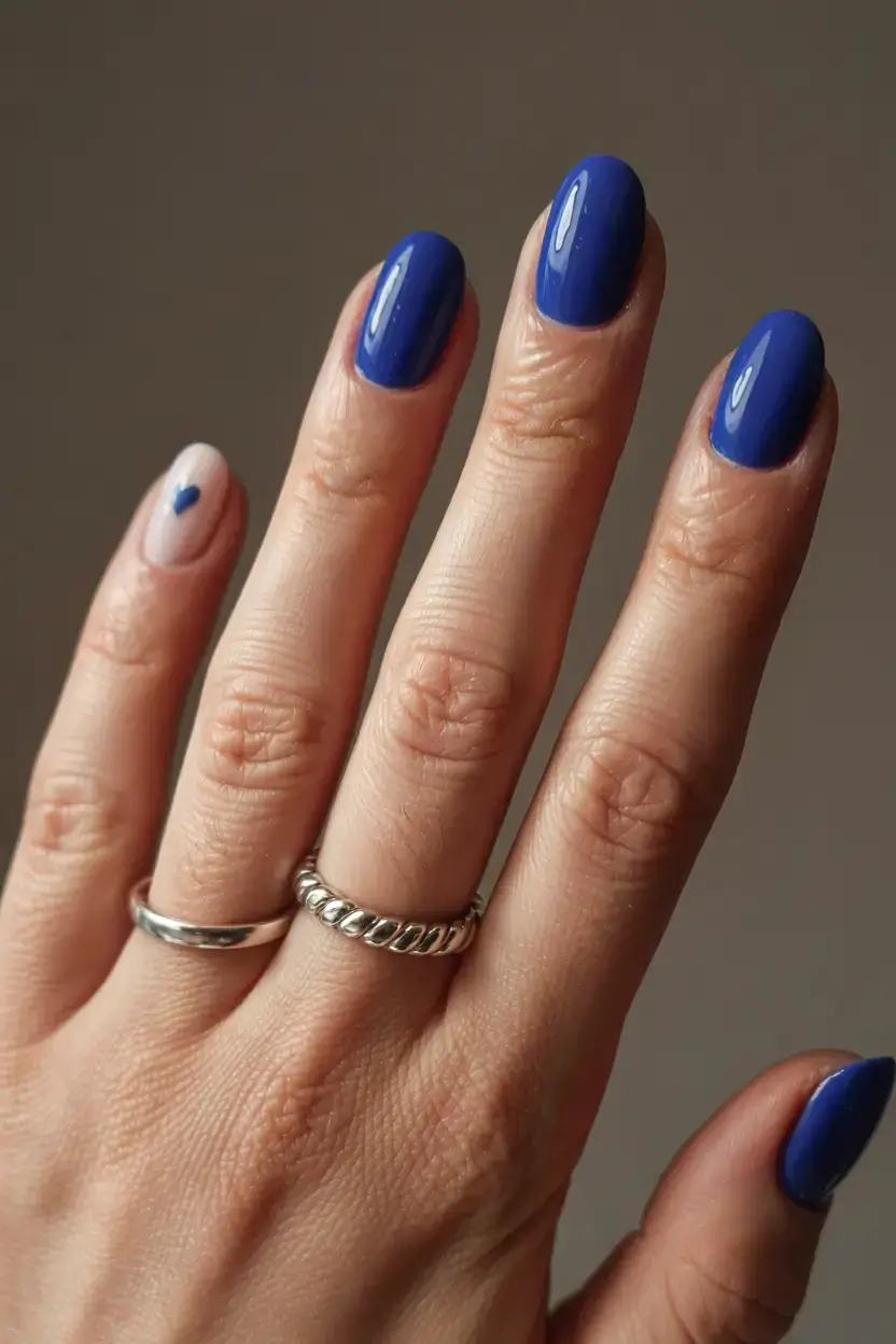 delicate spring oval nails 2026 Deep Blue Gloss with a Minimal Accent Detail