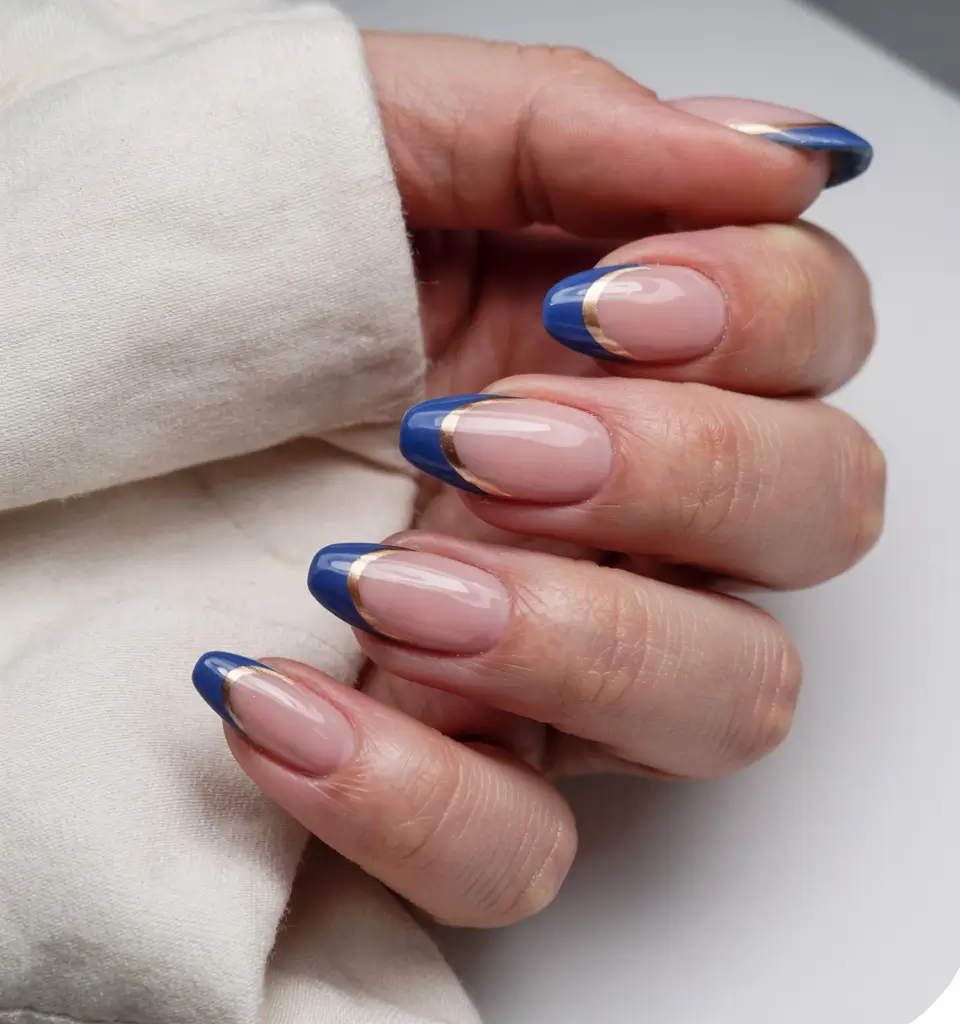 graduation nails ideas 2026 Deep Blue French with a Gold Accent Curve