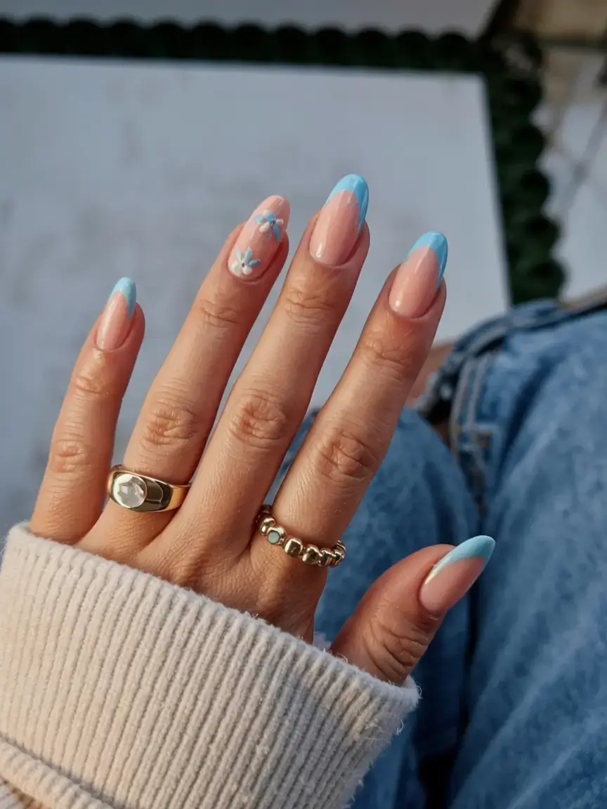 modern spring vacation nails 2026 Sky Blue French Tips with Delicate Floral Accent