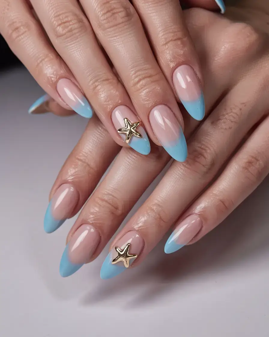 modern spring vacation nails 2026 Baby Blue French Tips with Gold Starfish Accent
