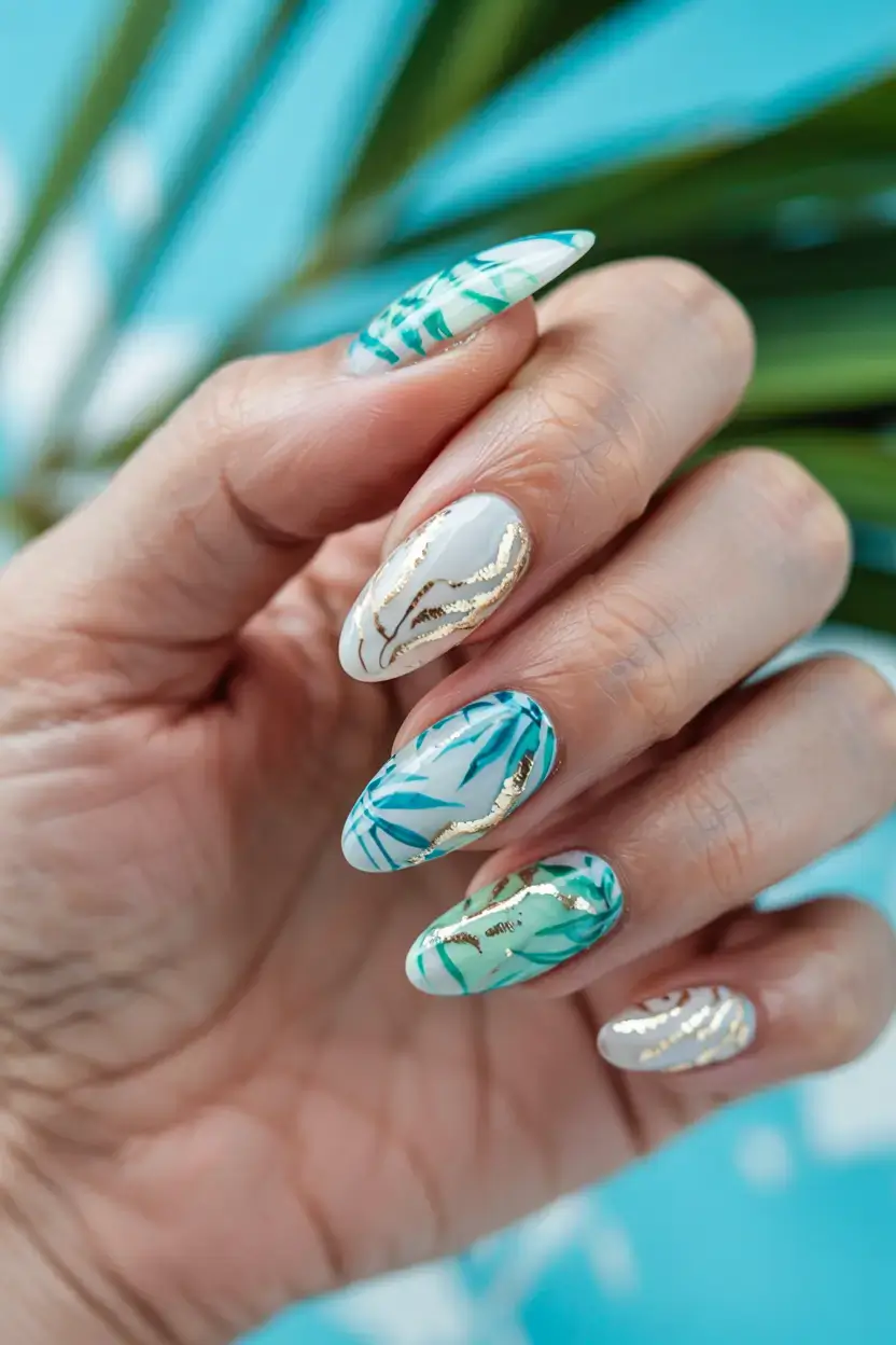 modern spring vacation nails 2026 Tropical Leaf Nail Art with Gold Details