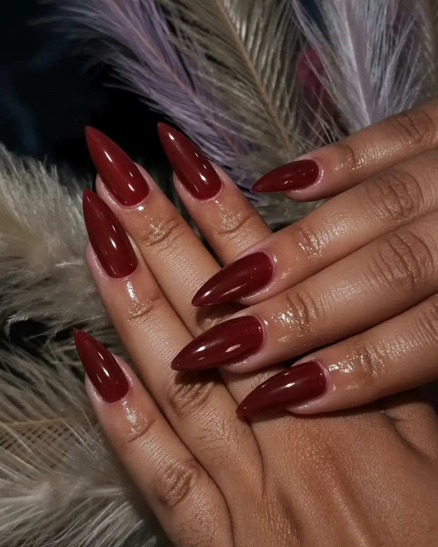 must try spring nails for dark skin 2026 Glossy Burgundy Stiletto Nails for Bold Spring Energy