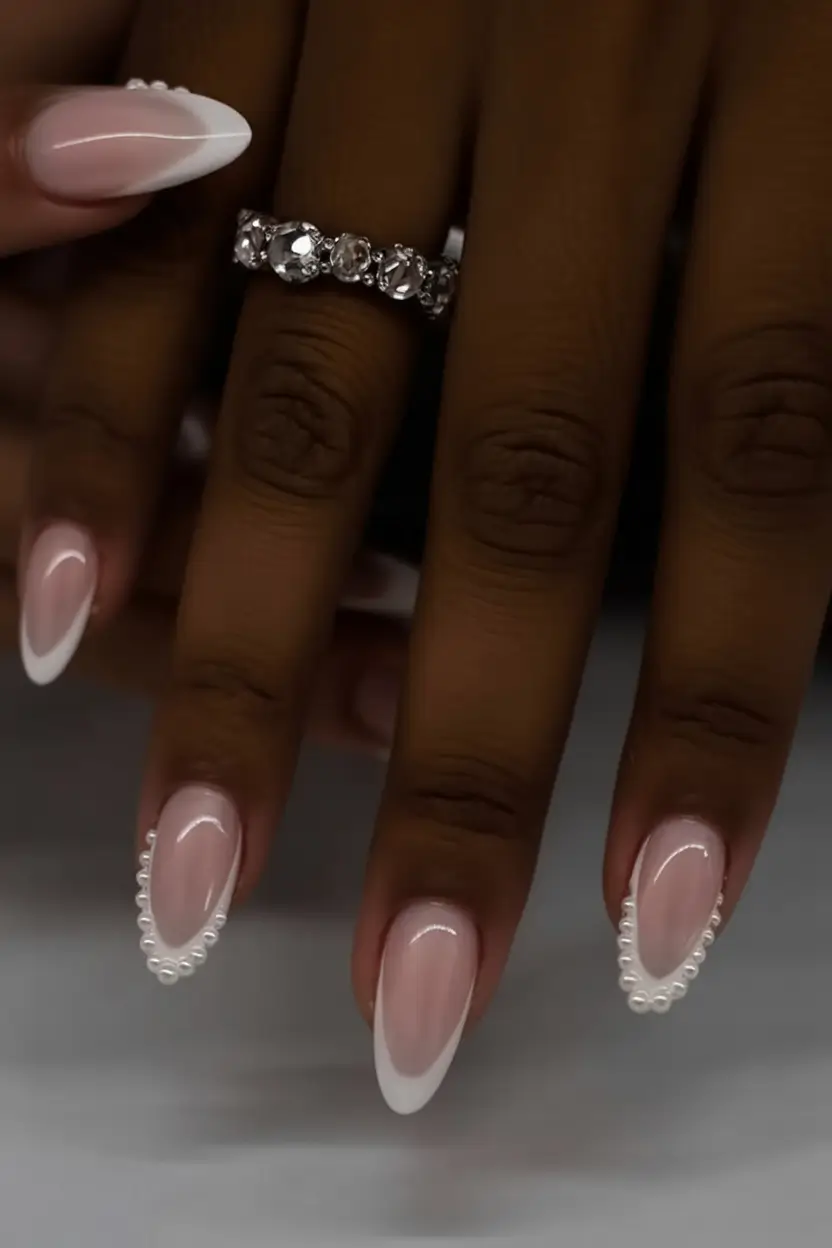 must try spring nails for dark skin 2026 French Almond Nails with Tiny Pearl Accents