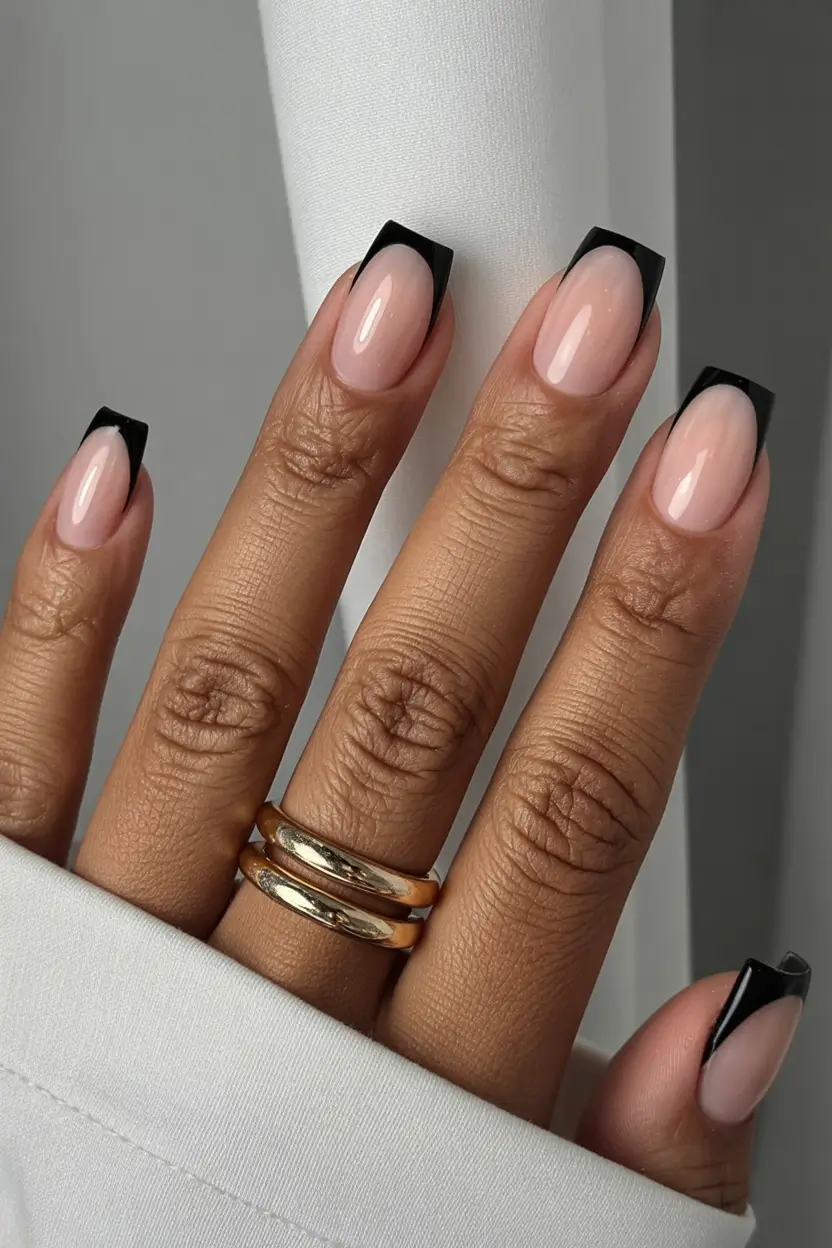 must try spring nails for dark skin 2026 Modern Black French Tips with Glossy Nude Base