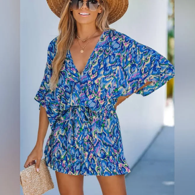 Sleeveless V-neck romper with elastic waist and vibrant abstract print