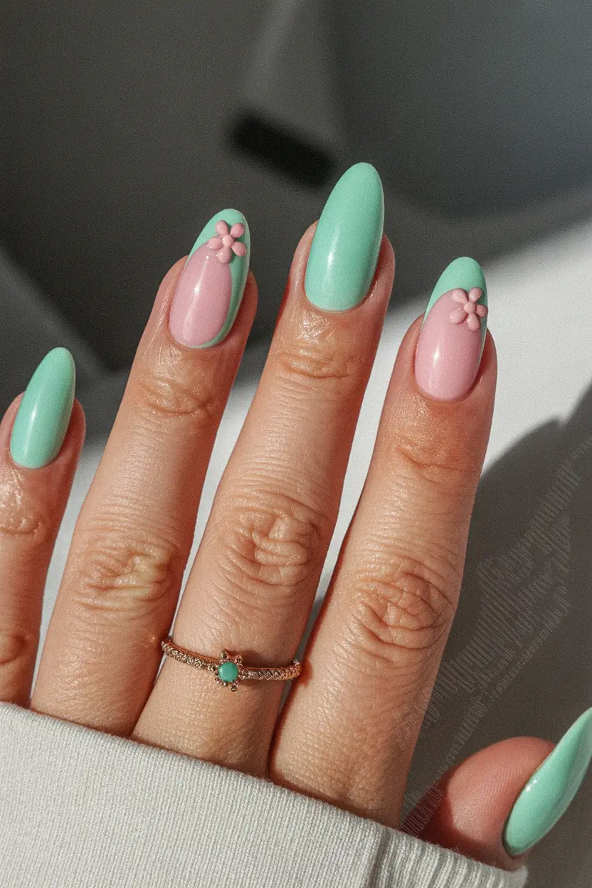 spring to summer season nail art ideas 2026 Mint French Almond Nails with Floral Accent