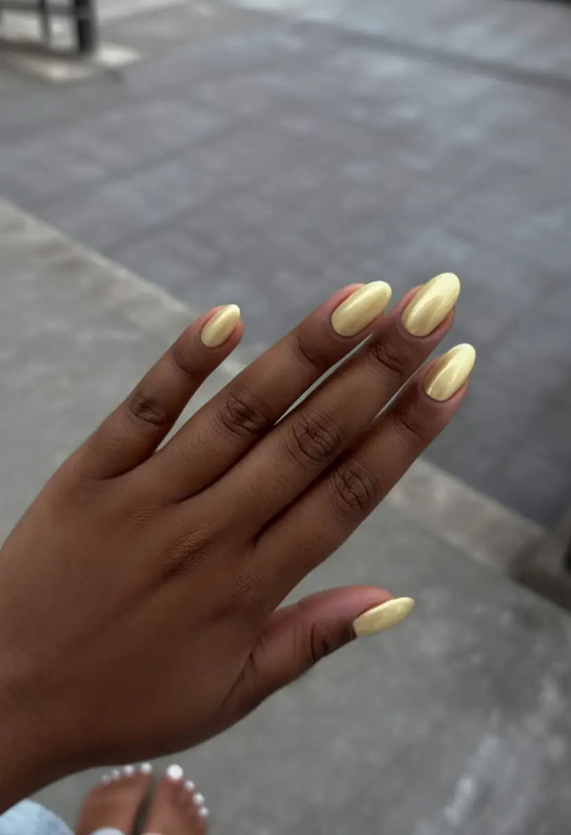 top spring nails for tan skin 2026 Butter Yellow Almond Nails That Instantly Brighten Tan Skin