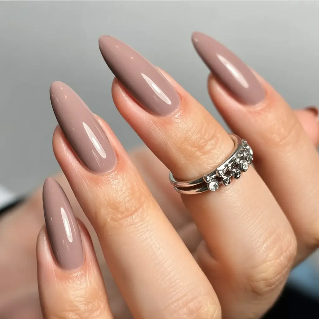 top spring nails for tan skin 2026 Glossy Taupe Almond Nails for a Sophisticated Neutral Finish