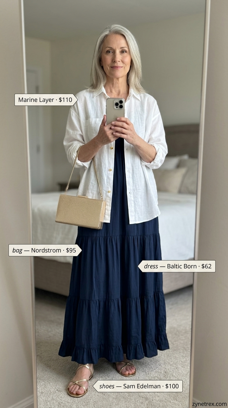 Classic summer outfit for women over 60 2026: Navy maxi dress, gold sandals, white linen shirt for evening.