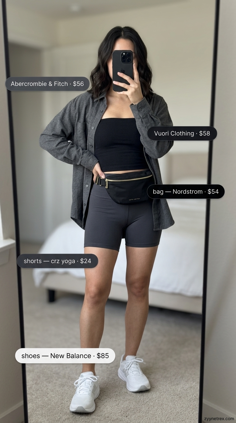 Athleisure Tube Top Comfort 2026 Athleisure outfit: black athletic tube top, grey oversized shirt, and biker shorts. Cute summer tube top outfits 2026.