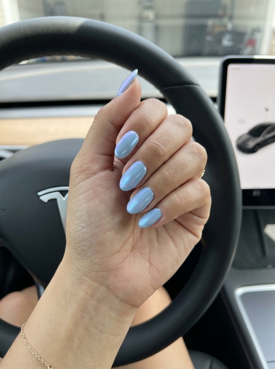 Sky Blue Chrome Oval Nails 2026 | Festival & Evening Cool Sky blue chrome oval nails with shimmer for summer 2026. Futuristic and cool for festivals.