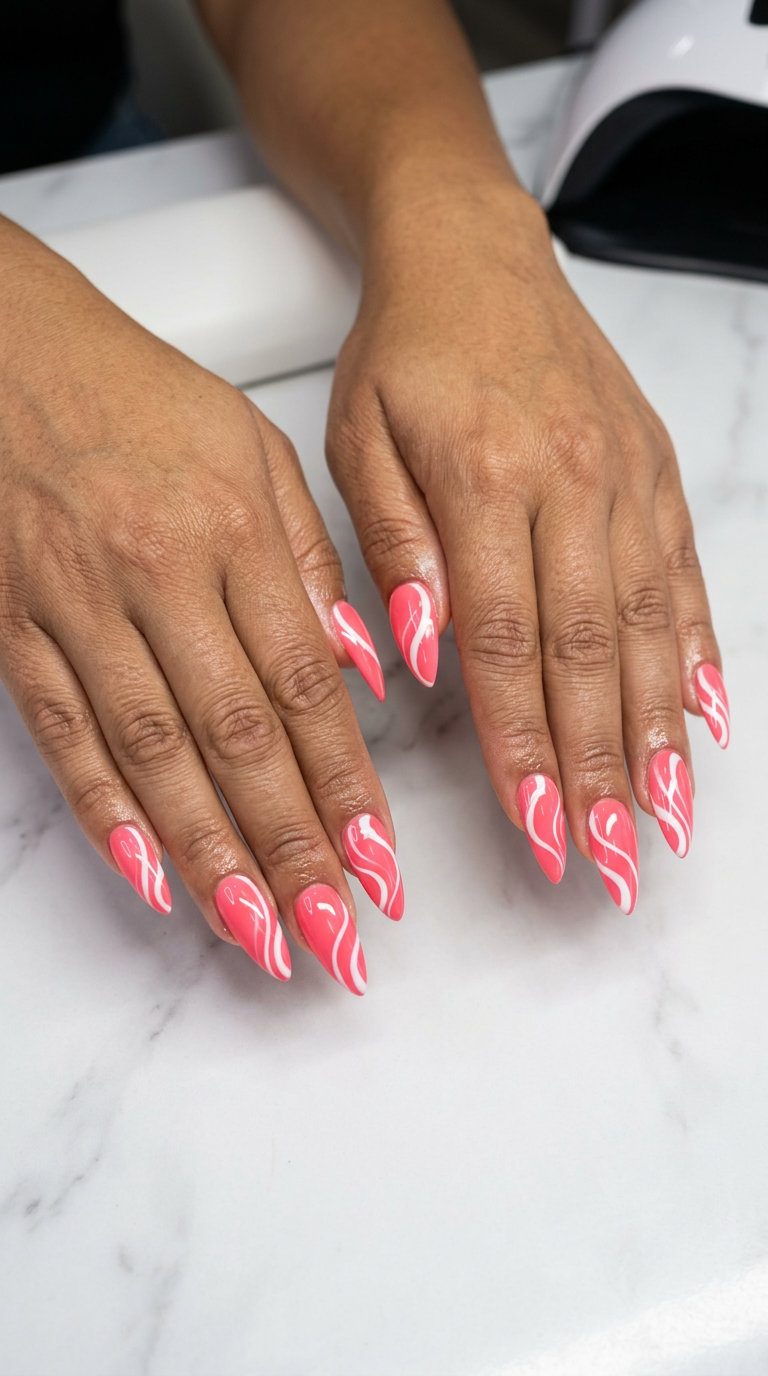 Coral Pink Abstract Swirl nails for summer festivals, featuring vibrant coral pink gel with bold white swirls.