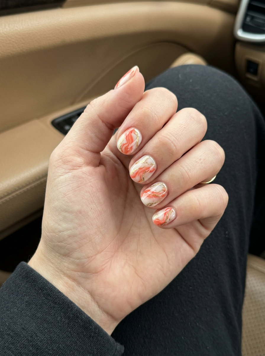 Short round summer nails 2026: Coral Stone Marble for formal events and date nights. Sophisticated and artistic.
