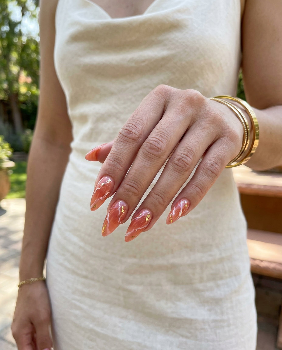 Coral Stone Stiletto nails 2026: Sophisticated sheer coral marble with gold flecks for formal events.