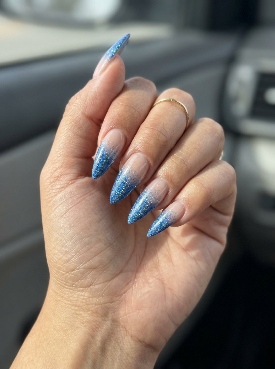Cosmic glitter gradient stiletto nails for summer 2026 date nights and concerts. Glamorous & sparkling.