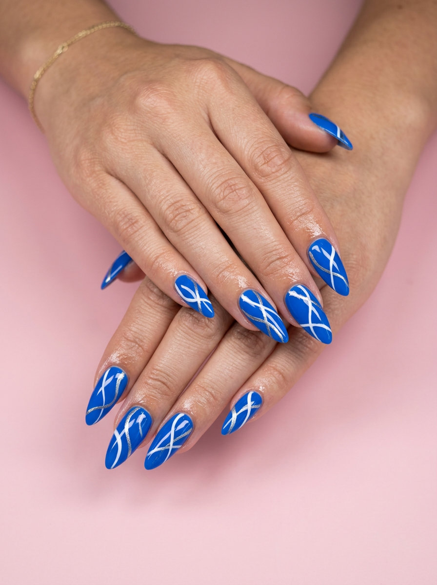 Geometric Electric Blue Abstract Stiletto nails 2026: Edgy blue, white, silver art for night outs.