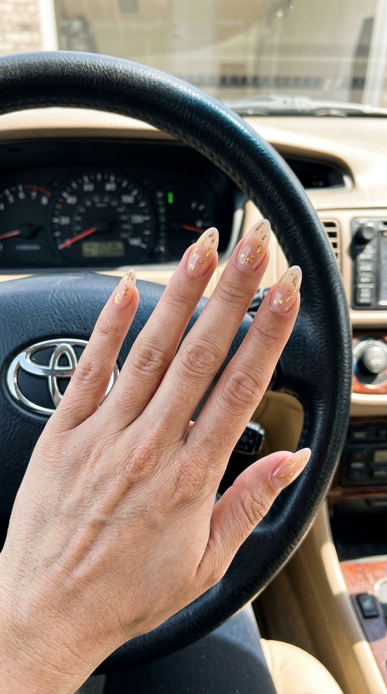 Elegant summer classy nails 2026: Sheer nude with scattered gold foil flakes for formal events.