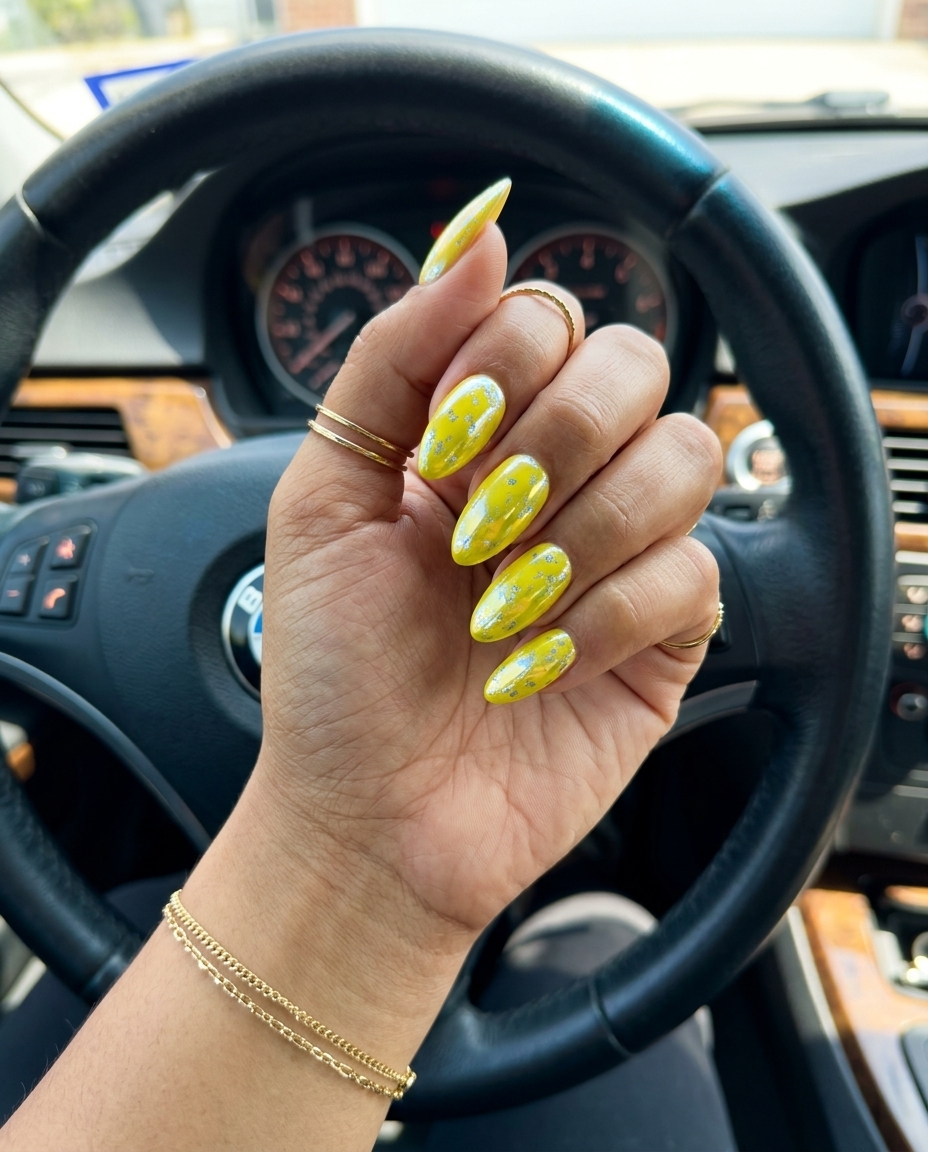 Opaque butter yellow oval nails with a high-gloss finish for daily wear and spring events. Clean-girl summer nail manicure ideas 2026.