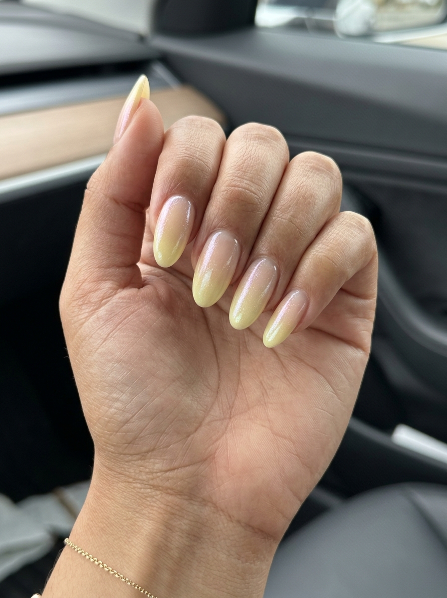 Romantic lemon chiffon yellow shimmer fade ombre on almond nails for summer nails yellow 2026 garden parties.