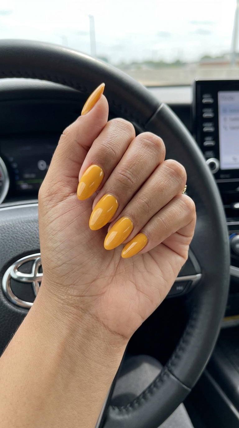 Bold vibrant marigold yellow solid glossy coffin nails for summer nails yellow 2026 date nights.
