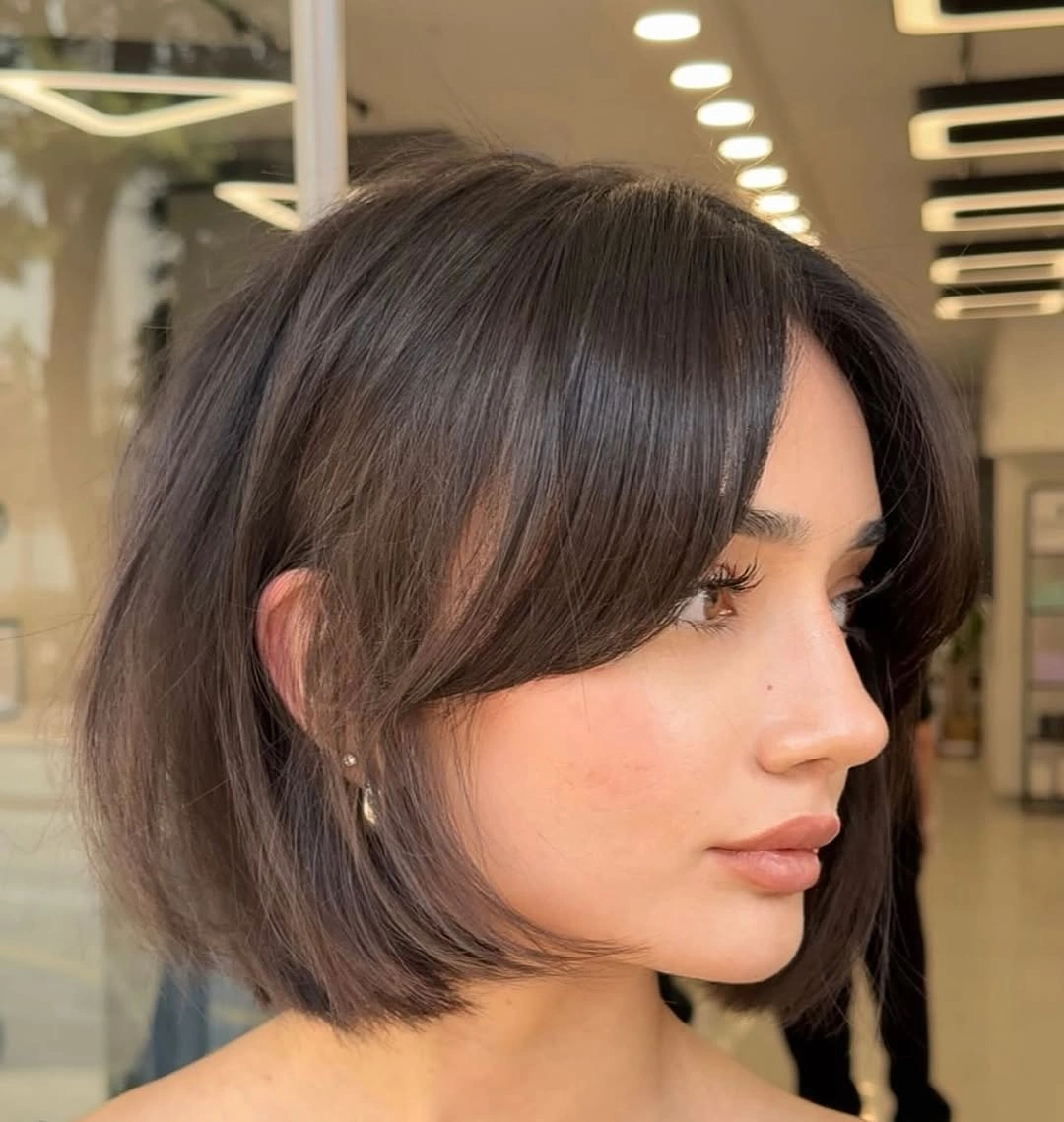 bobbed haircut for women Classic Brunette Bob With Soft Curtain Framing