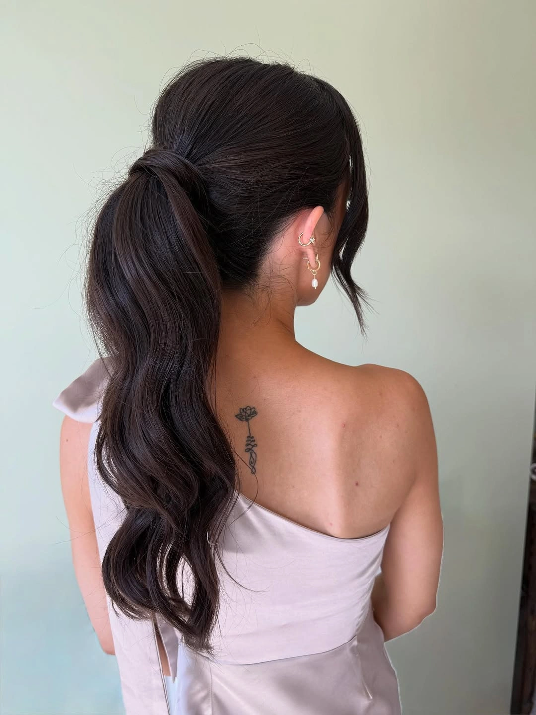 bridesmaid hairstyling Elegant Low Ponytail With Sleek Finish