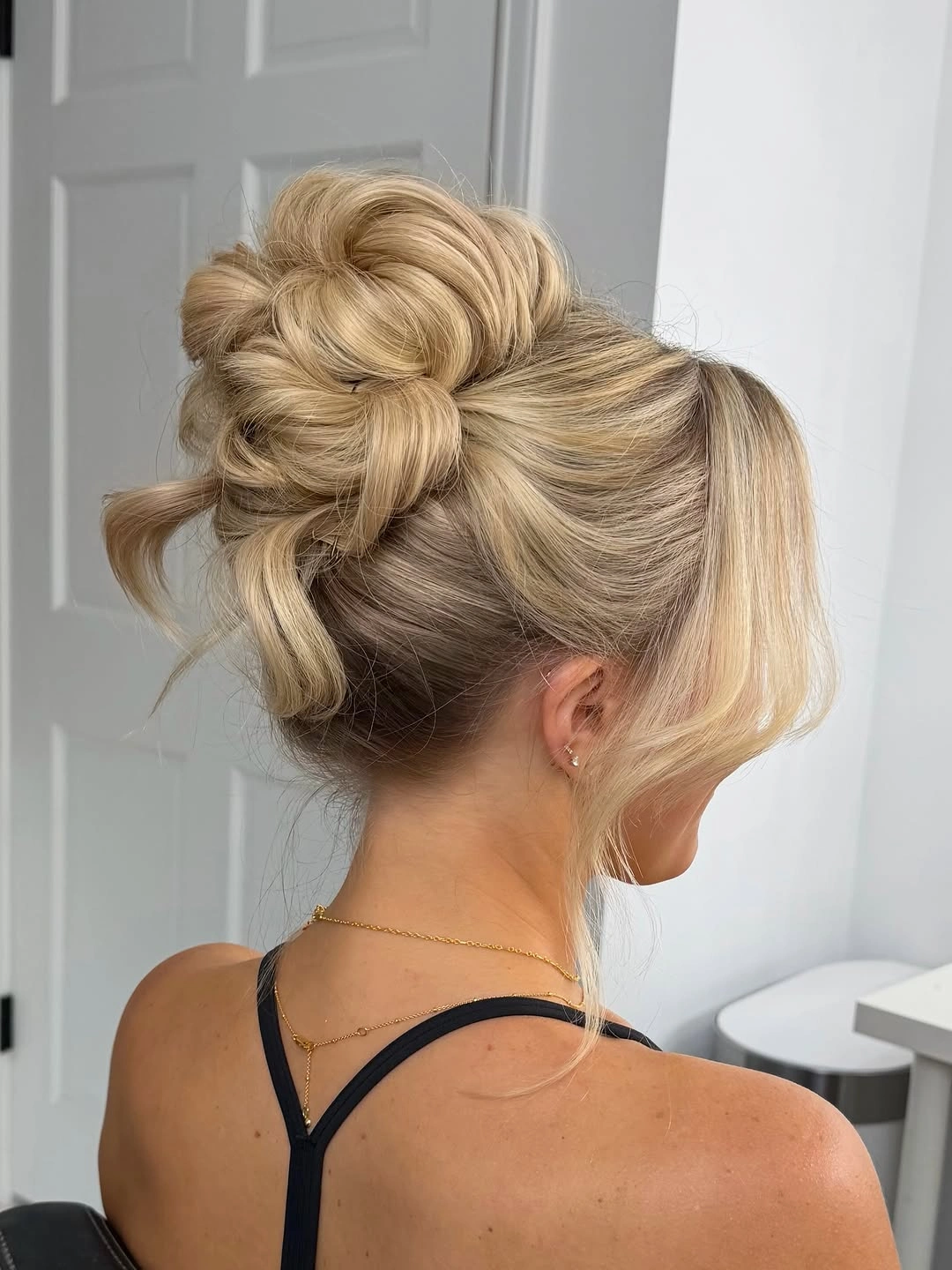 bridesmaid hairstyling Voluminous Textured Bridal Updo With Soft Curtain Bangs